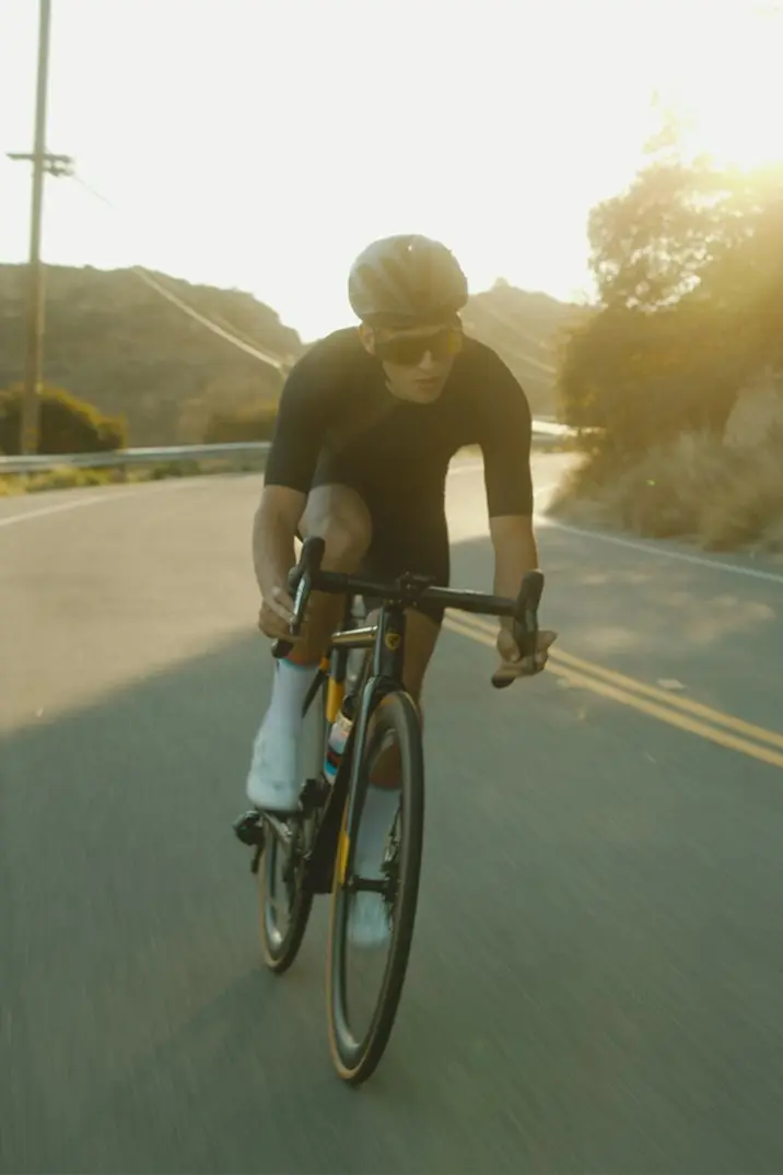man in black t-shirt riding bicycle on road during daytime
